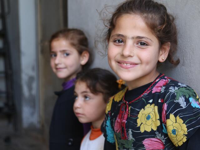 three young girls standing next to each other