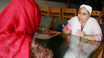 Razia speaking to a woman